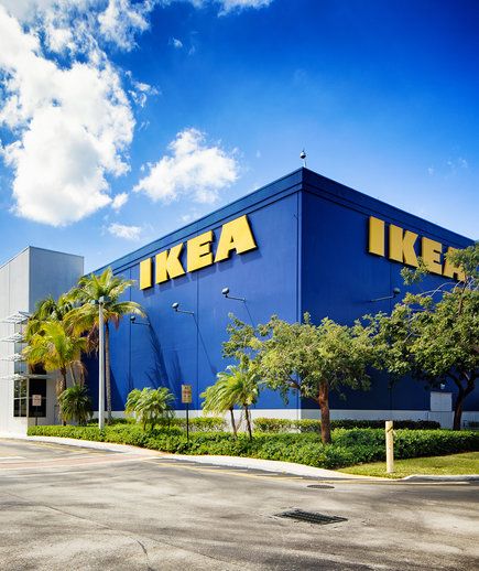 Corner view of the Ikea furniture store in Sunrise Florida near Fort Lauderdale on a mostly sunny Winter day. The image features the typical blue store with the yellow logo on its wall.