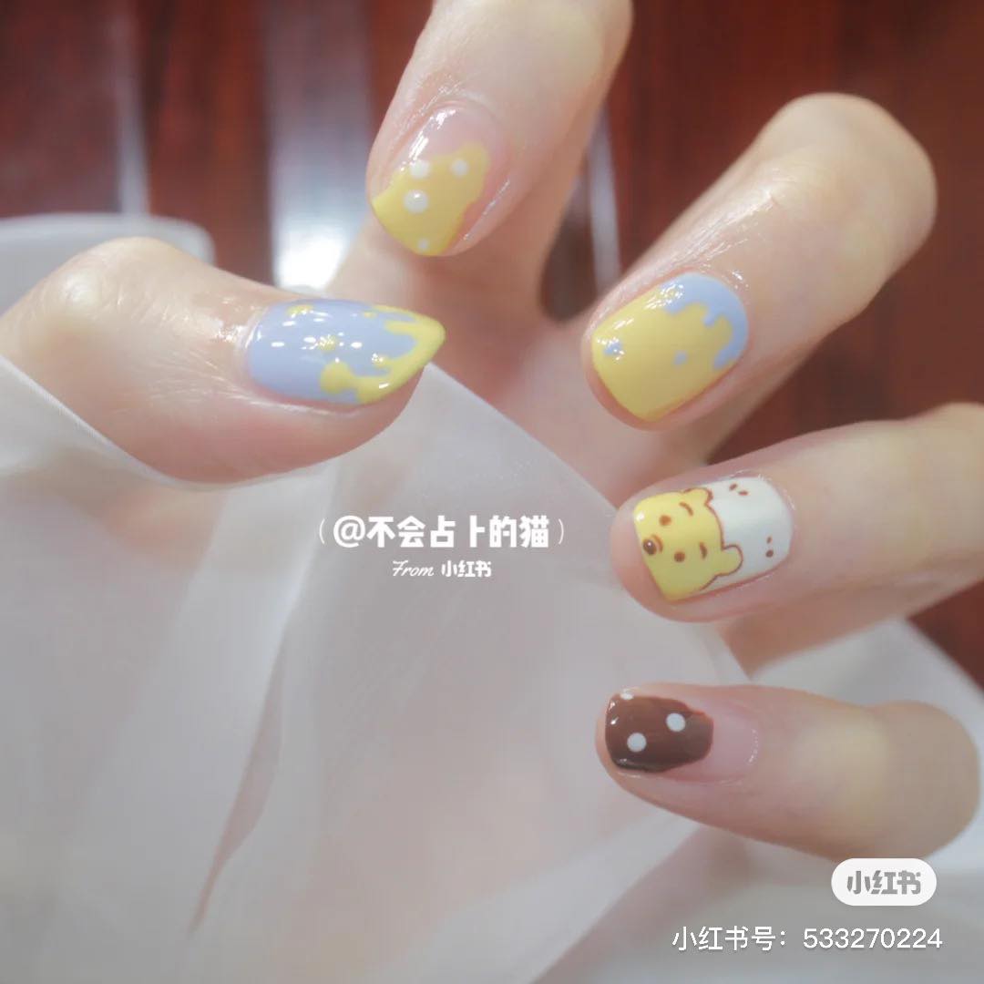 萌趣卡通系 · 晶莹清透系美甲 专属春夏季的清甜底色，搭配萌趣卡通、小花/水果元素瞬间可爱感炸裂！十指跳色不重样设计更添俏皮感，宝宝云朵蓝色系、柔嫩粉色系、梦幻香芋紫色系、百搭卡其色系都是很夯的选项～