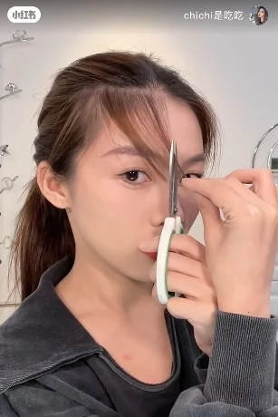 另一只手则拿着刷出来的头发,轻轻从鼻子旁边的位置垂直(就和鼻子的位置是平行的)剪下来。